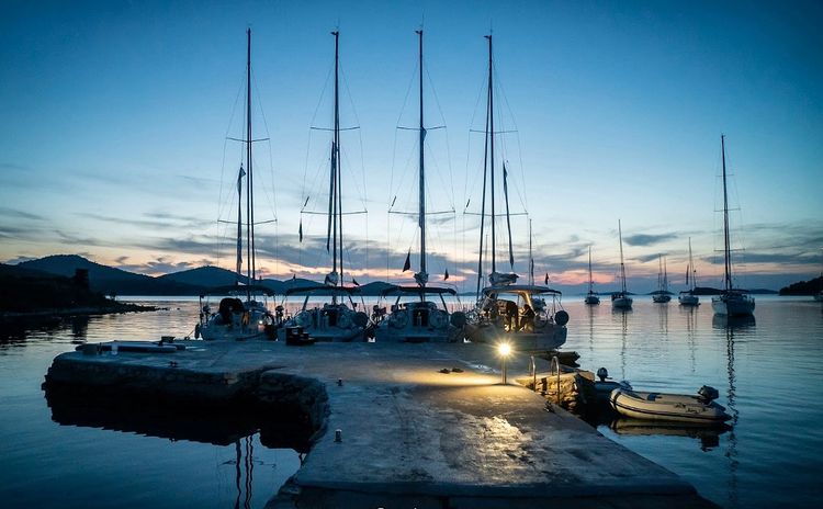 Yachts at the pier and mooring buoys in Strunac Bay