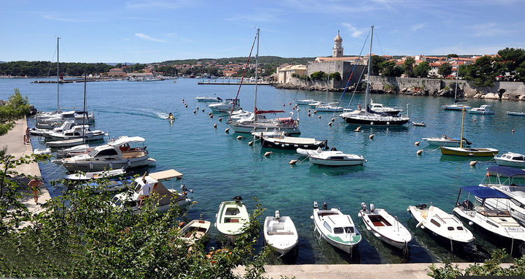 Yachts on mooring buoys in the eastern bay of Krk