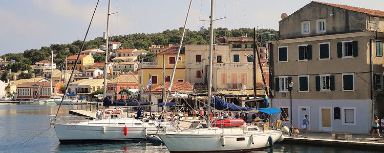 Yachts at the waterfront in Port Gaios. Paxos Island. Ionian Sea. Greece.