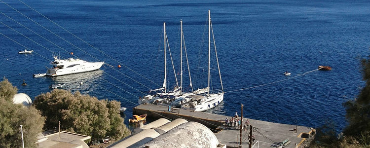 Yacht mooring at the pier of Oia village