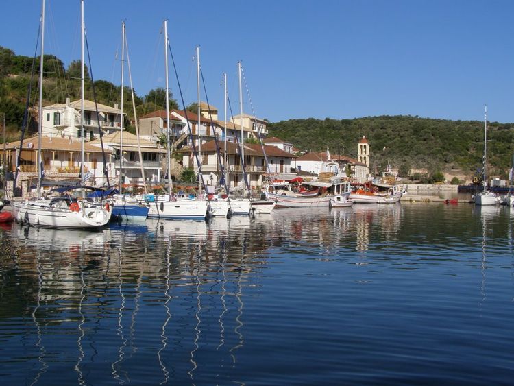 Yacht mooring at the pier of the inner port of Vathi on Meganisi Island. 