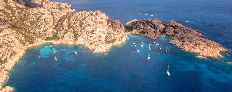 Yachts at anchor in the bay of Cala Caticcio on Caprera Island