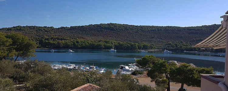 Yacht mooring at buoys in Mala Lamjana Bay