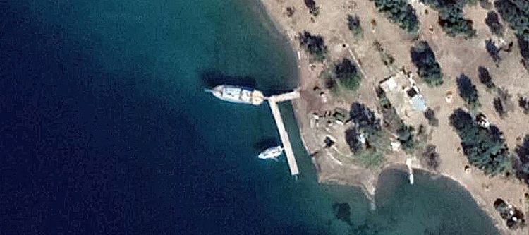 Yachts anchorage and the pier in Seagull Bay on the photo from space. Scopea Limani. Turkey