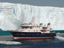 Hanse Explorer cruising past a huge tabular ice berg in Antarctica