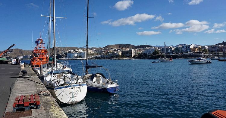 Yachts at the west breakwater in the fishport of Arguinegu