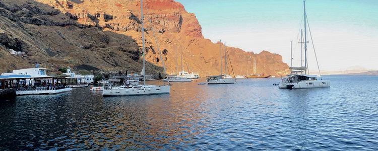 Yacht mooring at the buoys in St. Nicholas Bay on Thirasia Island