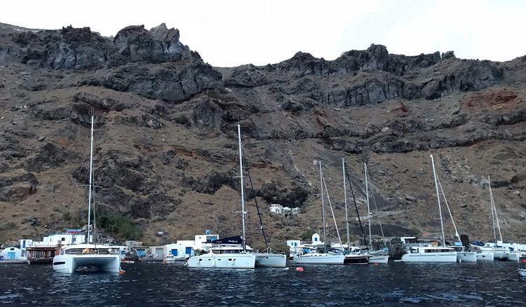 Yacht mooring at the buoys in Agios Nicholaos Bay on Thirasia Island