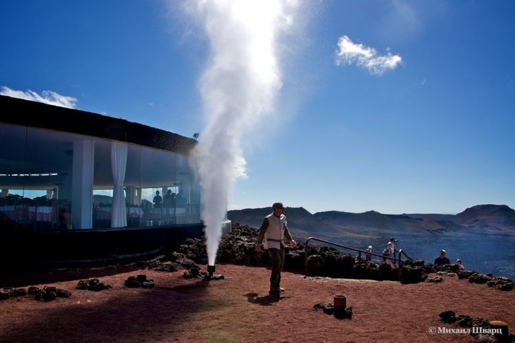 Fountain of steam after pouring a bucket of water down the pipe