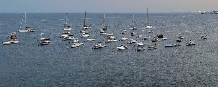 Yacht mooring on buoys at Aci Trezza